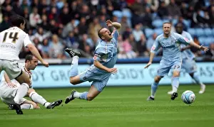 Prints of Coventrys Michael Doyle is tripped by Hulls Damien Delaney during the Coca-Cola Football League Championship match at Ricoh Arena, Coventry Coca-Cola Football League Prints: Coventry City vs. Hull City: Championship Clash – Michael Doyle Tripped by Damien Delaney (2007)