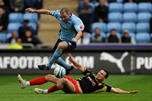Images Dated 2010 May: Coventry City vs. Watford: Battle for the Ball - Stephen Wright Leaps Clear of Don Cowie (Championship)