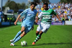 Images Dated 18th August 2012: Coventry City vs Yeovil Town: Barton Outmaneuvers Reid in Npower League One Clash at Huish Park