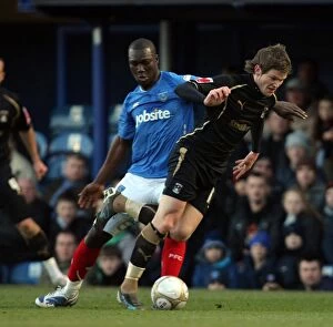 Images Dated 2nd January 2010: Coventry City's Aron Gunnarsson Evades Portsmouth's Papa Bouba Diop in FA Cup Third Round Clash at