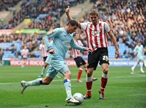 Images Dated 5th November 2011: Coventry Citys Lukas Jutkiewicz (left) and Southamptons Jos Hooiveld (right) battle for the ball