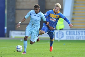 Images Dated 2013 August: Cyrus Christie vs Curtis Main: Tense Moment in Coventry City's Sky Bet Football League One Clash vs Shrewsbury Town