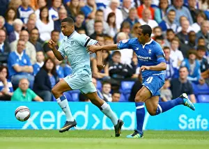 Images Dated 2011 August: Cyrus Christie vs Jean Beausejour: Tense Moment in Birmingham City vs Coventry City Football Match