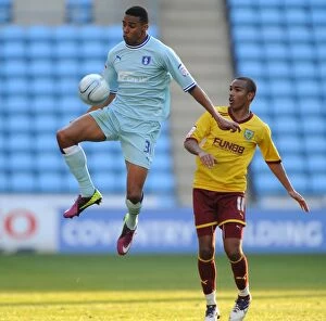 Images Dated 22nd October 2011: Cyrus Christie vs. Junior Stanislas: Npower Championship Clash at Ricoh Arena (2011)