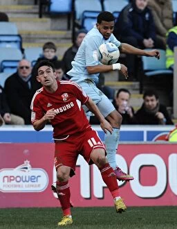 Images Dated 2nd March 2013: Cyrus Christie Wins the Ball: Coventry City vs Swindon Town in Npower League One at Ricoh Arena