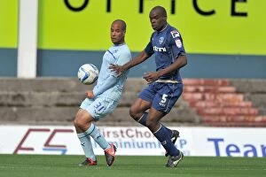 Oldham Athletic v Coventry City : Boundary Park : 29-09-2012 Collection: David McGoldrick vs. Jean Yves Mvoto Owono: A Fierce Battle for Possession in Coventry City's