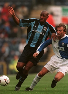 Images Dated 1997: Dion Dublin's Determined Standoff Against Blackburn Rovers in FA Carling Premiership Clash