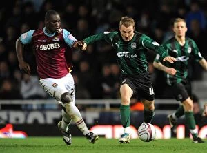 Images Dated 2nd January 2012: Diop vs McSheffrey: A Championship Showdown at Upton Park (West Ham United vs Coventry City, 2012)