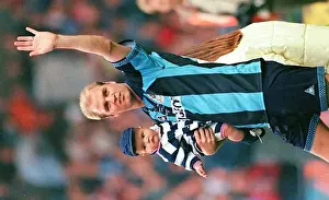 A Heartfelt Moment of Gratitude: David Busst and Son Cobi Thank Crowd at Coventry City's Benefit Match vs. Manchester United (1990s)