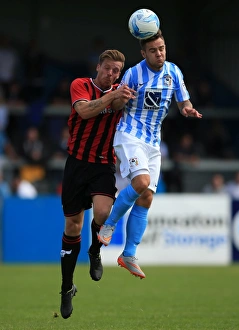Intense Header Battle: Armstrong vs Mullins in Coventry City's Pre-Season Clash with Oxford United