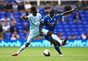 Images Dated 13th August 2011: Intense Rivalry: Bigirimana vs. Gomis - The Battle for Ball Supremacy between Coventry City