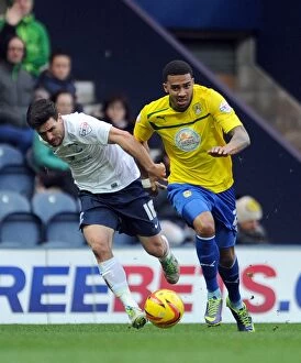 Images Dated 18th January 2014: Intense Rivalry: Buchanan vs. Christie's Battle for Possession in Preston North End vs