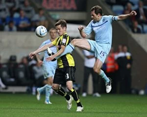 Images Dated 4th September 2012: Intense Rivalry: Coventry City vs Burton Albion in the Johnstones Paint Trophy at Ricoh Arena
