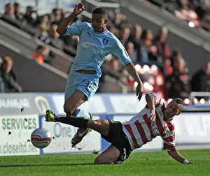 Images Dated 2011 October: Intense Rivalry: Cyrus Christie vs Kyle Bennett Battle for Ball Supremacy in Coventry City vs Doncaster Rovers