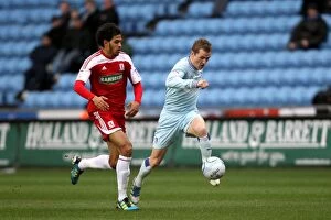 Images Dated 21st January 2012: Intense Rivalry: McSheffrey vs. Haroun Battle for Ball Supremacy (Coventry City vs)