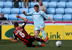 John Fleck vs Joe Partington: Intense Tackle in Coventry City vs Bournemouth Npower League One Match at Ricoh Arena