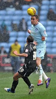 Images Dated 4th February 2012: Keogh Soars Over Chopra: Coventry City vs Ipswich Town Championship Showdown at Ricoh Arena