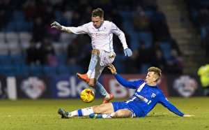 Images Dated 2015 January: Leap of Determination: Danny Swanson Evasions Jake Hessenthaler in Coventry's League One Battle