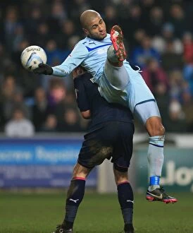 Images Dated 10th January 2013: Leon Clarke vs Joel Byrom: Coventry City vs Preston North End in the Johnstones Paint Trophy