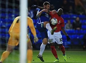 Images Dated 25th March 2016: Michael Bostwick vs Marc Antoine Fortune: Intense Battle for Ball Possession in Peterborough
