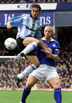 Mid-Air Battle: Hadji vs Elliott in the FA Carling Premiership Clash at Filbert Street