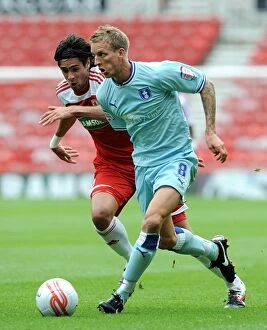Images Dated 27th August 2011: Middlesbrough vs Coventry City: Clash between Rhys Williams and Carl Baker in Championship Action