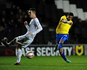 Images Dated 29th December 2012: Milton Keynes Dons Shaun Williams Dodges Cyrus Christie's Shot in Npower League One Clash