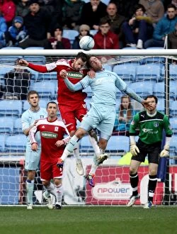 Images Dated 21st January 2012: Richard Keogh and Middlesbroughs Matthew Bates battle for the ball