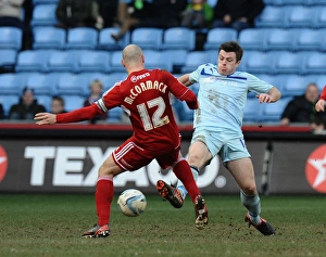 Images Dated 2013: Steven Jennings vs Alan McCormack: Intense Tackle in Coventry City vs Swindon Town Npower League One Match