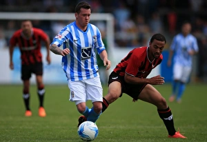 Prints of Coventry Citys Danny Swanson holds off challenge from Oxford Uniteds Liam Secombe Pre-season Friendly Prints: Swanson vs Secombe: A Pre-Season Battle at Liberty Way Stadium - Coventry City vs Oxford United