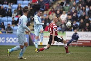 Images Dated 29th March 2013: Tense Shootout: Callum Ball Faces Off Against Rob Jones at Coventry City vs Doncaster Rovers