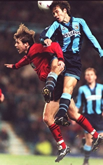 Thrilling Leap: Kenny Cunningham Soars Over Eion Jess in Coventry City vs Wimbledon Clash (Carling Premier League)